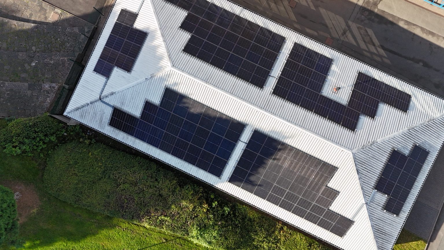 Aerial photograph of a commercial roof with solar panels